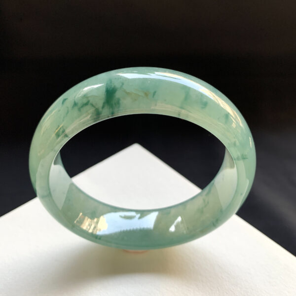 Real jade bracelet worn on wrist in natural light