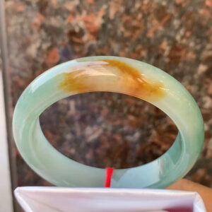 Real jade bracelet icy oil-green with yellow veins front view