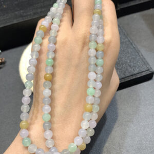 Real jade necklace with 6mm multicolor beads laid out flat