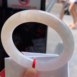 Front view of chunky red jade bangle with sweet glossy red hue