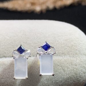 Front view of 18K white ice jade huggie earrings showcasing smooth white jade and polished gold setting