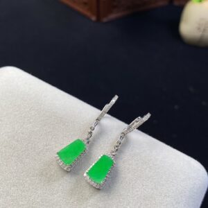 Front view of 18K bright green Burmese jade earrings featuring smooth Wushi plaque design