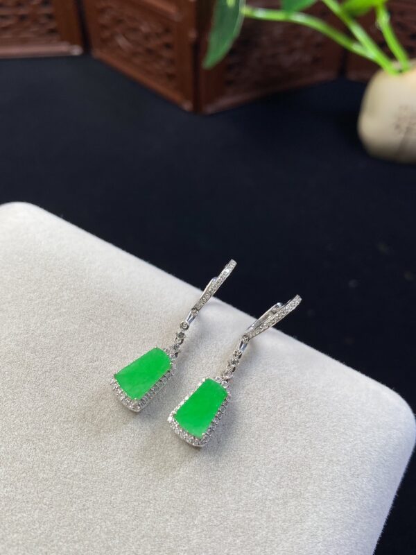 Front view of 18K bright green Burmese jade earrings featuring smooth Wushi plaque design