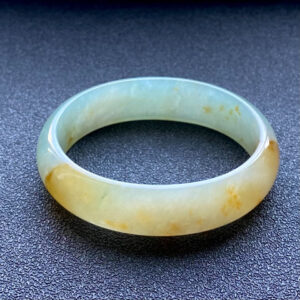 Yellow jade princess bangle with natural floral patterns, front view