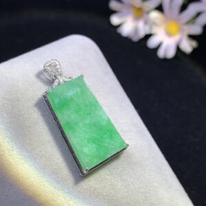 Close-up of 18K fruit green Wu Shi jadeite pendant showcasing vibrant natural jade colors and intricate carving
