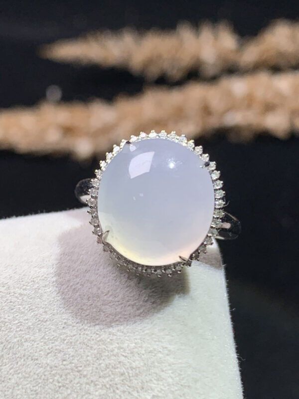 Front view of 18K white ice jadeite ring with oval cabochon gemstone