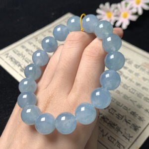 Full view of blue base jade bracelet beaded with 12.4mm beads