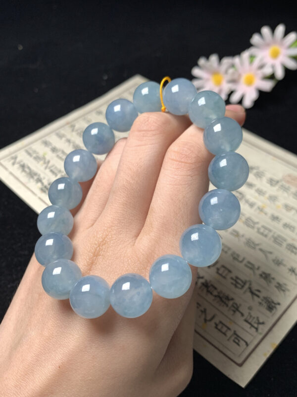 Full view of blue base jade bracelet beaded with 12.4mm beads