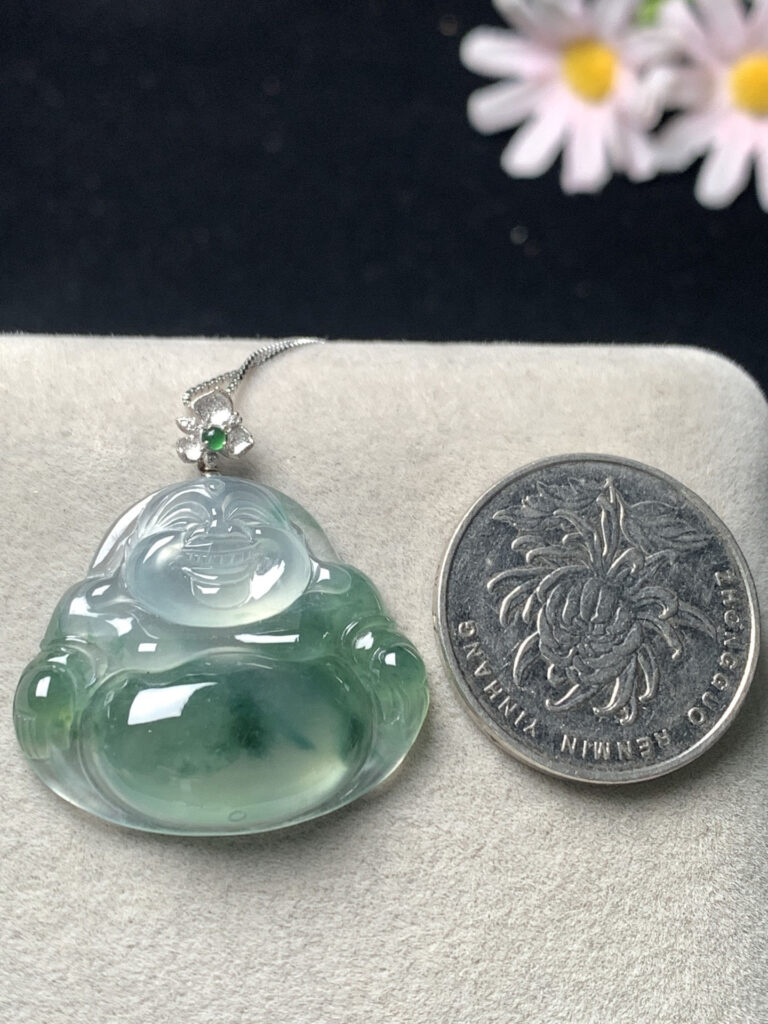 Close-up of person wearing ice green jade Buddha necklace