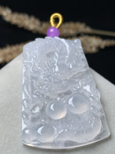Dragon jade pendant worn as a necklace on a model
