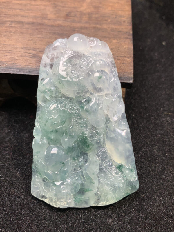 Natural jadeite dragon pendant with icy white base and floral patterns, measuring 59.5×37.5×6.3mm, exquisite dragon jewelry carving.