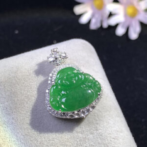 Close-up of 18K gold green buddha pendant carved from full green jadeite