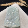 Icy jade dragon necklace close-up showing intricate dragon carving