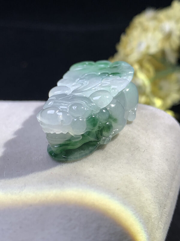 Front view of icy jade Pixiu pendant with floating green patterns
