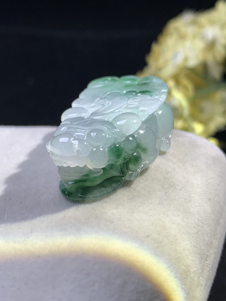 Front view of icy jade Pixiu pendant with floating green patterns