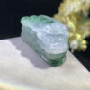 Side angle of jade Pixiu pendant highlighting its thickness and craftsmanship