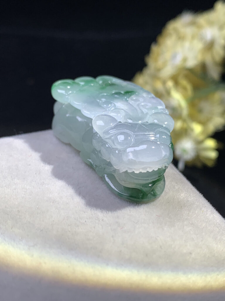 Side angle of jade Pixiu pendant highlighting its thickness and craftsmanship