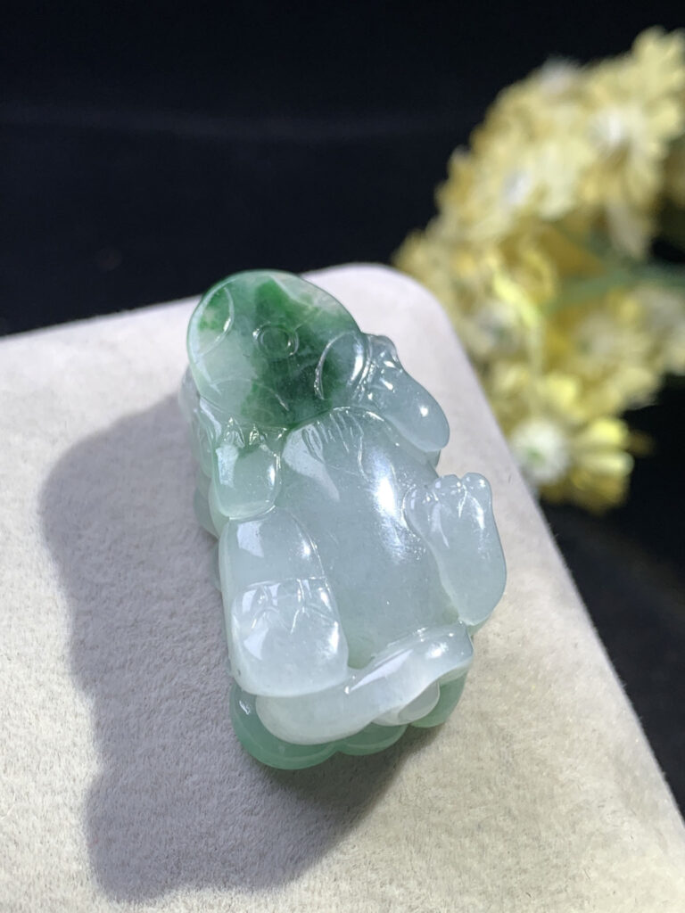 Icy jade Pixiu pendant worn on a red silk cord necklace