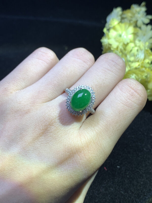 Jade rings worn on hand with imperial green stone and gold band