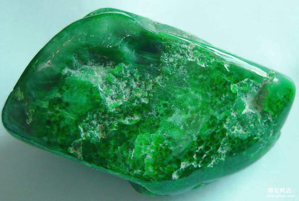 Jadeite gemstone held up to light showing translucency and inner glow