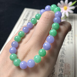 Real jade bead bracelet with 8mm alternating green and lavender jadeite beads on a neutral background