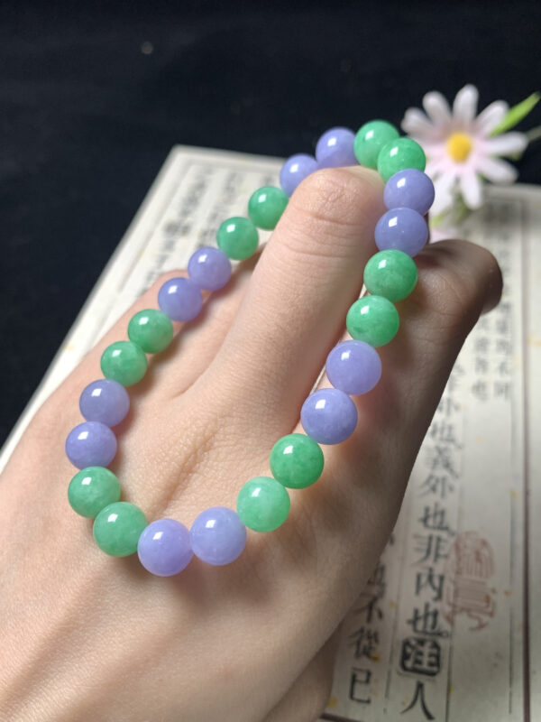 Real jade bead bracelet with 8mm alternating green and lavender jadeite beads on a neutral background