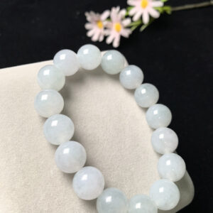 Stylish wrist wearing 13mm white jadeite beads bracelet with ice elastic cord, showcasing natural translucent jade colors