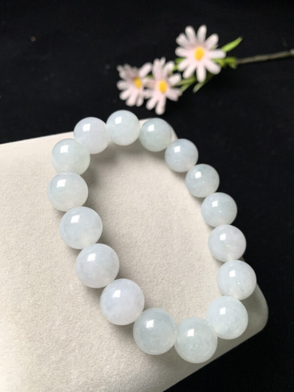 Stylish wrist wearing 13mm white jadeite beads bracelet with ice elastic cord, showcasing natural translucent jade colors