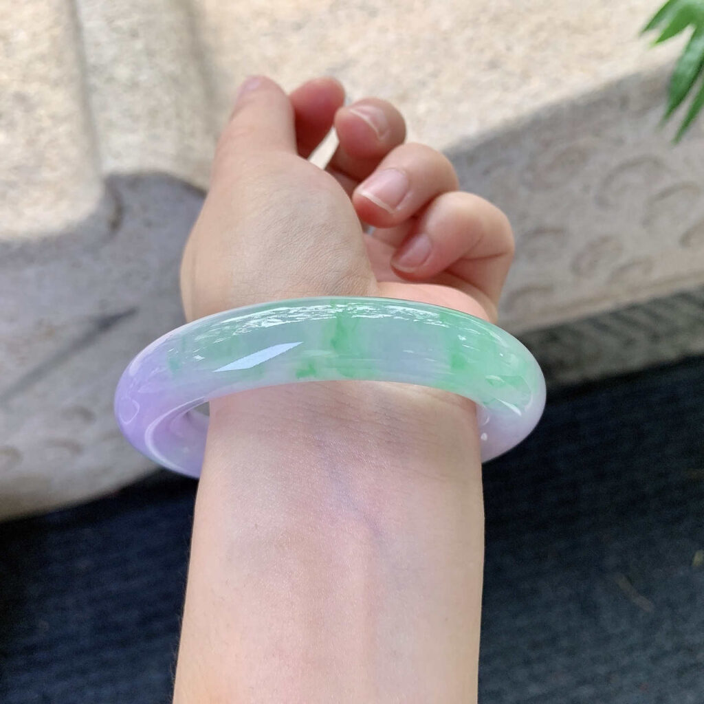 Close-up of jade bracelet worn on wrist representing emotional connection and personal energy — what does a jade bracelet mean personally?